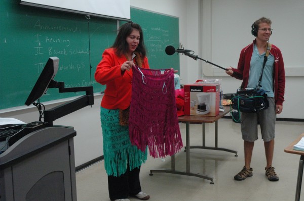 Sandy Navarro shows off two skirts that she bought on sale - and never wore - in a class presentation on buyer's remorse