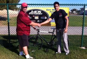 Freshman Syed Rab won a Schwinn bicycle in a drawing for students enrolled in intramural sports last fall; with Wayne Timmerman, program assistant, DHi. Courtesy of George Wing