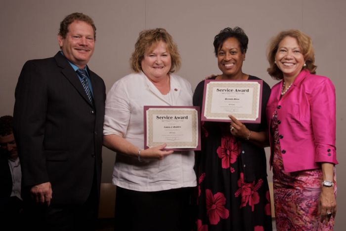 Laura Robles, interim dean, College of Natural and Behavioral Sciences (at center left) and Brenda Blow, academic resource manager, College of Extended and International Education, were honored by President Mildred GarcÃ­a and Provost Ron Vogel for 35 years of service