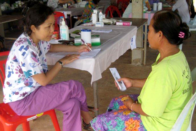 Nop Ratanasiripong (left) provides health screenings in Thailand.