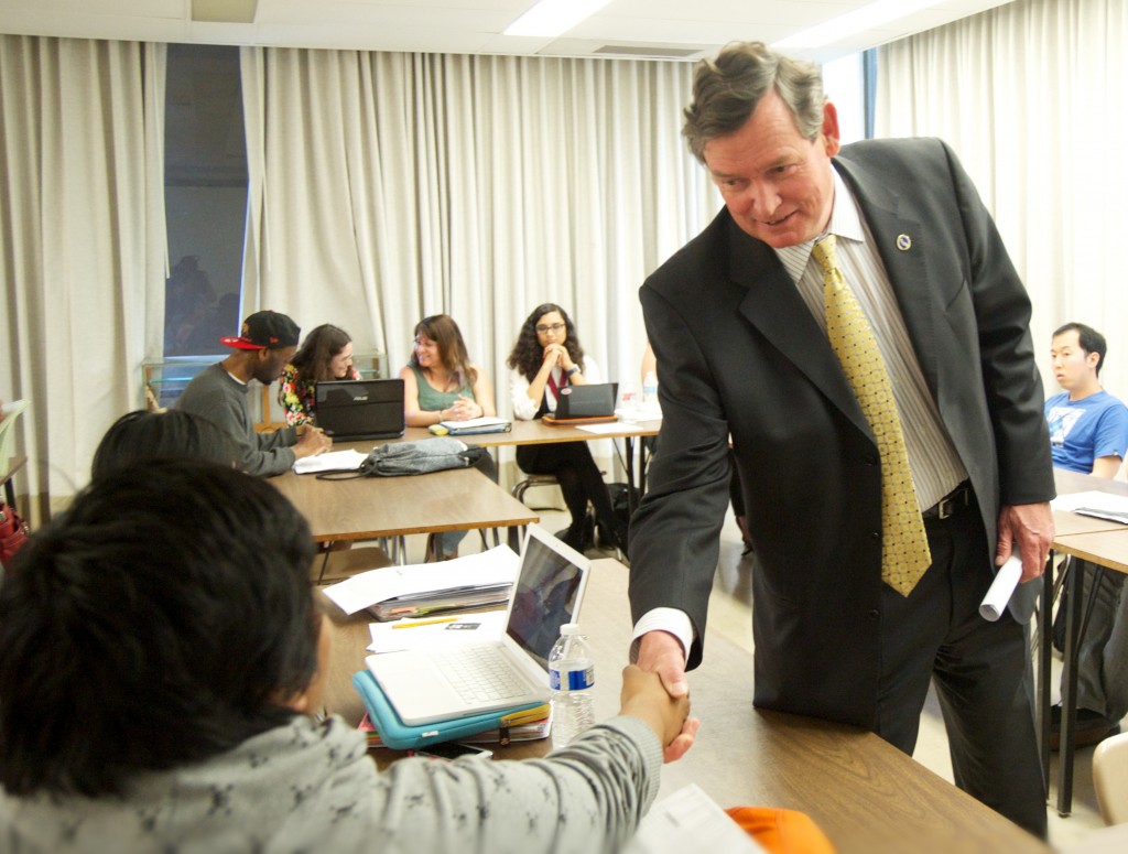 CSU Chancellor Timothy P. White talks with a student during an anthropology class.