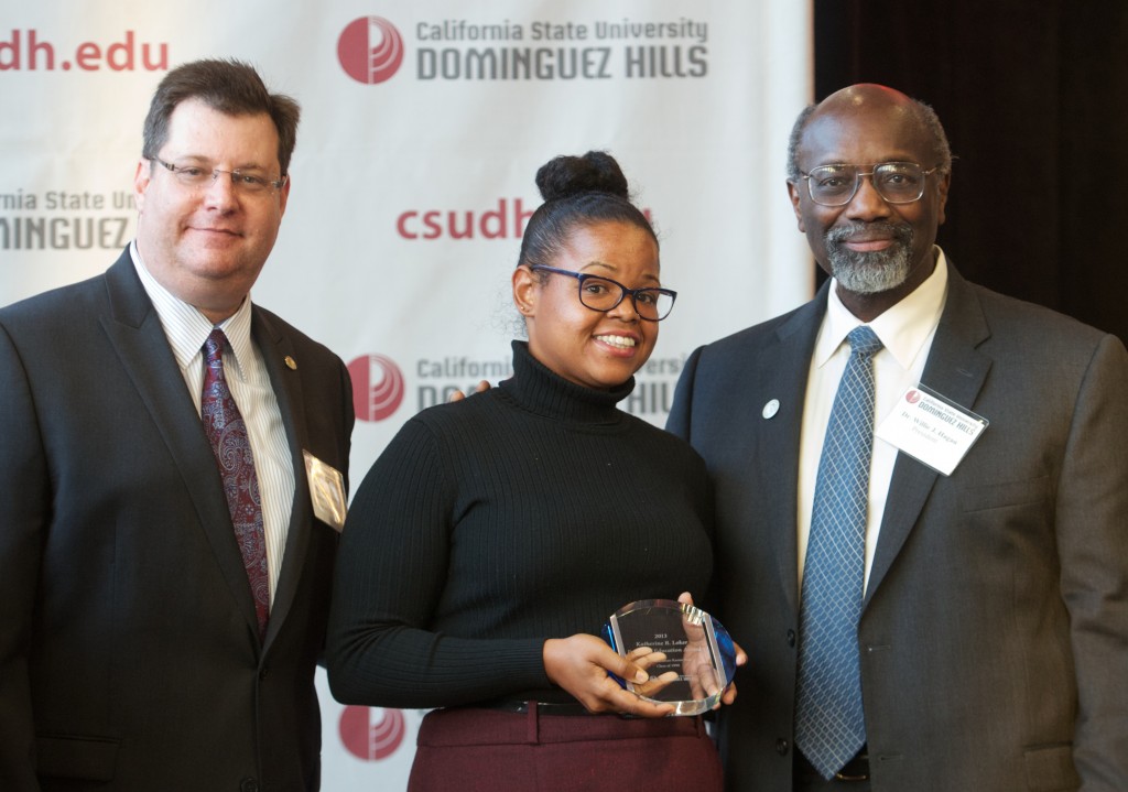 Alumna Keshia Sexton (Class of '08, B.A., XXX), who is the senior field deputy for Congresswoman Karen Bass accepts an award for Bass who was unable to attend the reception.