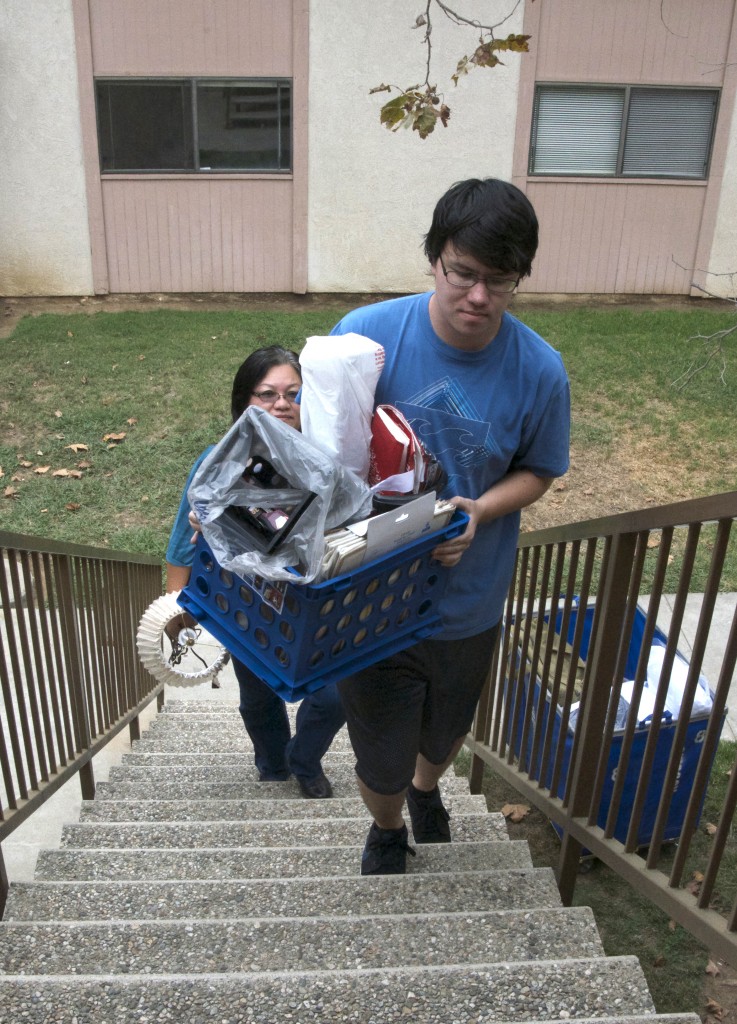 Ryan VanVleet moves into his upstairs apartment with the help of his mother, Angie Koo.