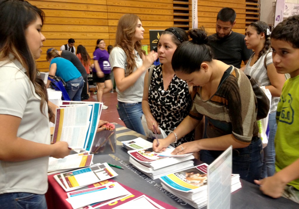 CSUDH student volunteers hand out informative materials to fair visitors.
