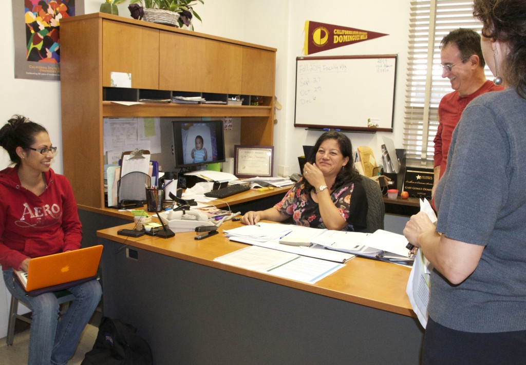 Gaby Gomez-Dominguez shares banter with biology department personnel.