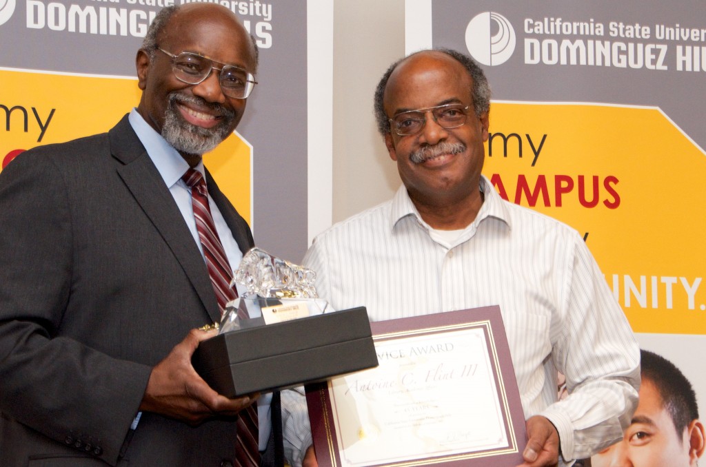 University President Willie J. Hagan congratulates Antoine Flint for 45 years of service as a full-time staff member.