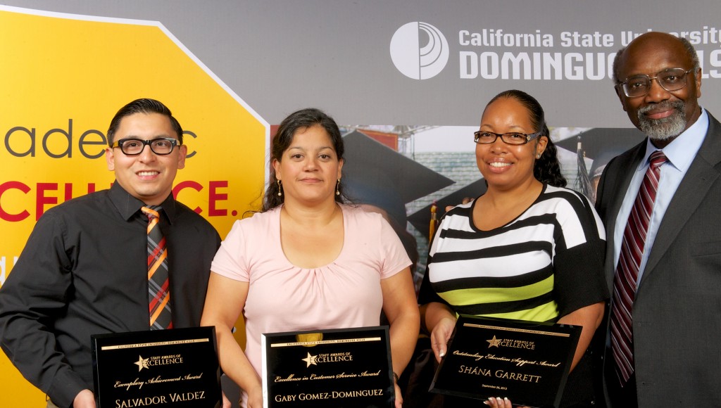 Salvador Valdez, Gaby Gomez-Dominguez, and Shána Garrett receive the 2013 Staff Awards of Excellence from President Hagan.