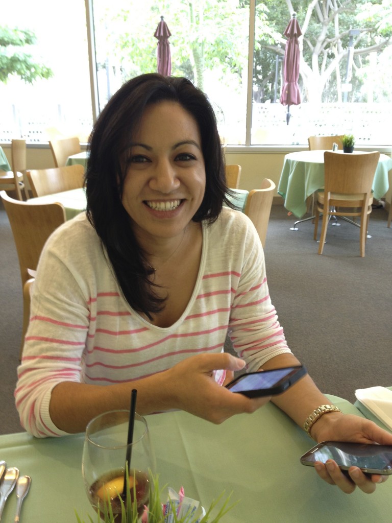 Bree Nguyen stays connected with clients by using her mobile devices while on a recent visit to CSU Dominguez Hills.