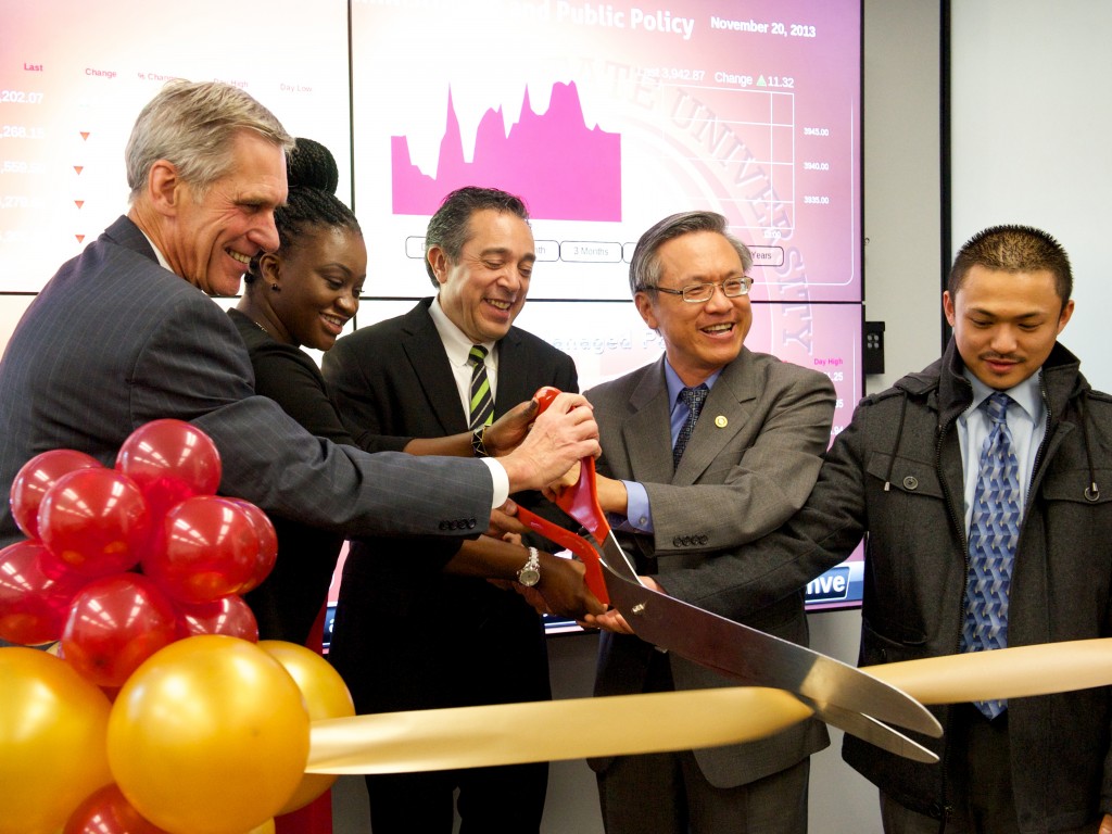 Cutting the ribbon to officially open the CBAPP Market Financial Trading Lab are Gary Reichard, interim provost and vice president for Academic Affairs; Djeneba Myriam Coulibaly past president of ASI; Sam Enriquez, alumnus and senior editor of Page One at the Wall Street Journal; CBAPP Dean Joseph Wen; and Gavin Centeno, ASI president.