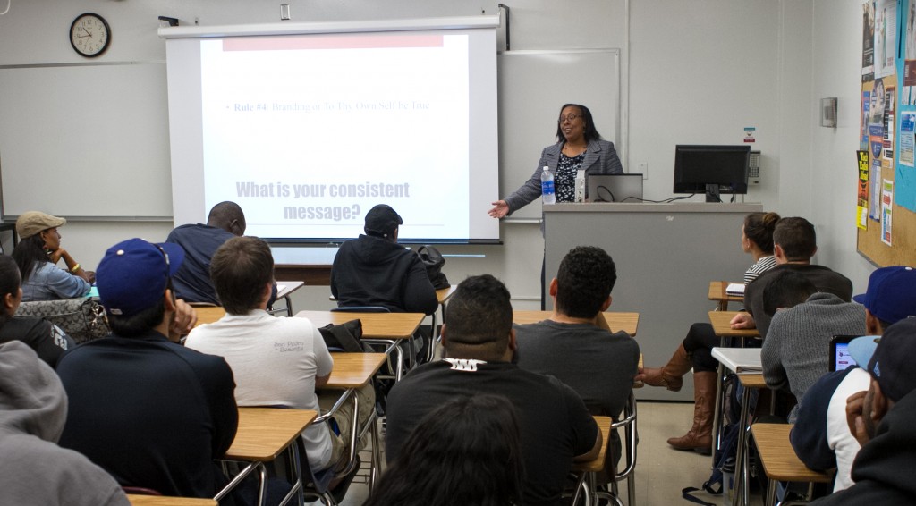 Tonya Haynes (Class of '04), CEO and founder of Phoenix Business Development Group, gives pointers to students in a Principles of Marketing class.