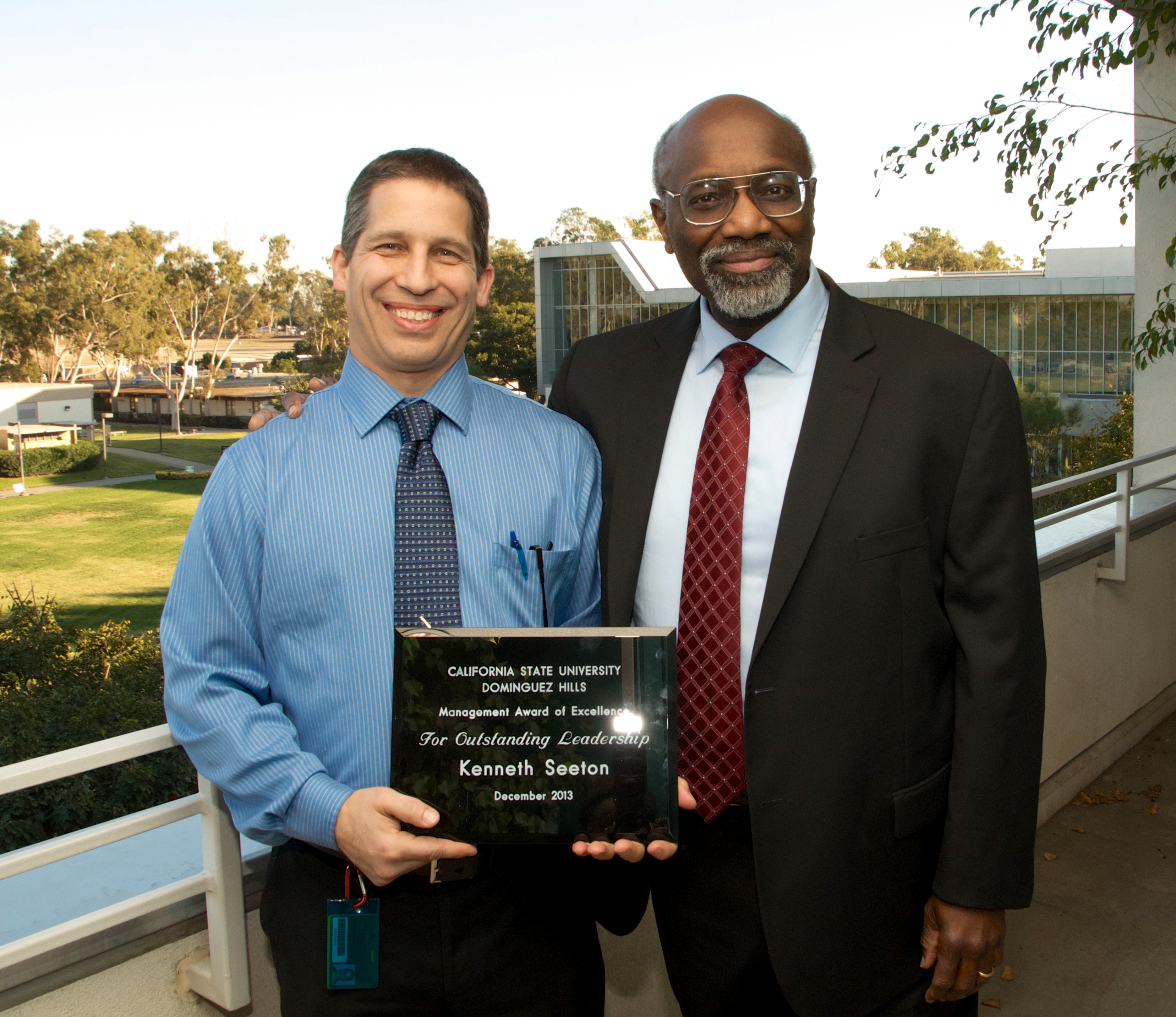 University President Willie J. Hagan presents Kenny Seeton with the 2013 Management Excellence Award.