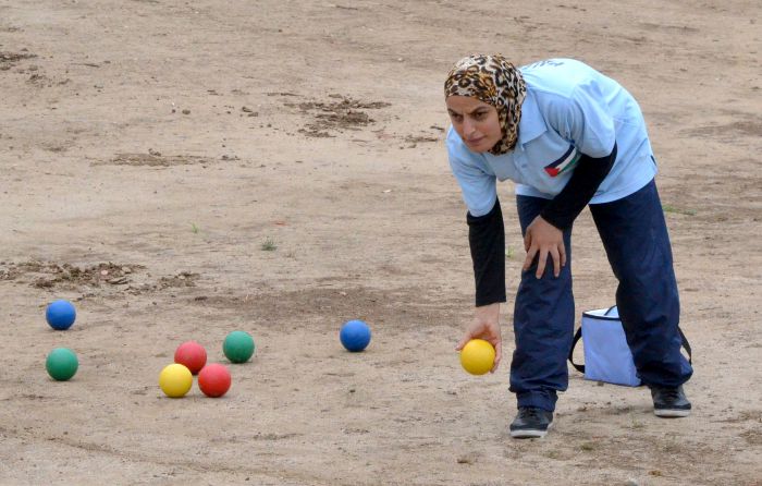 Palestinian woman plays bocce