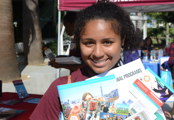 Freshman Ariyana Williams shows off information packets from the booths she visited at the Study Abroad Fair.