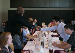 President Hagan shakes the hand of a scholar, Matthew Yu.