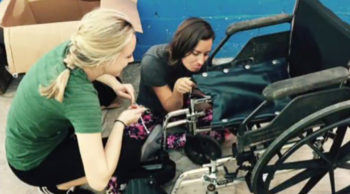 Students Kelly Archer and Laurelin Hefter repair a wheelchair at the center.