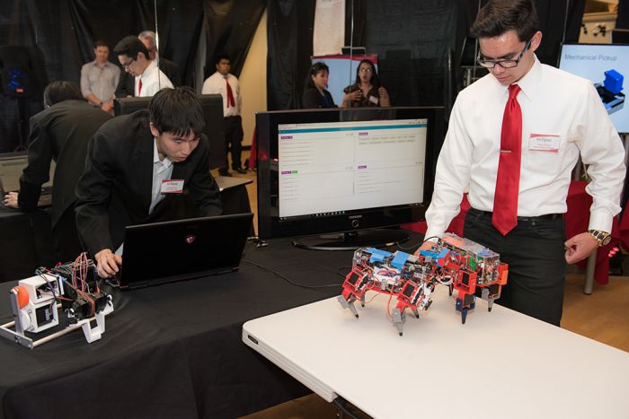 CAMS student and AHSOP scholar Troy Daley prepares his team’s custom-made robot during a student showcase.