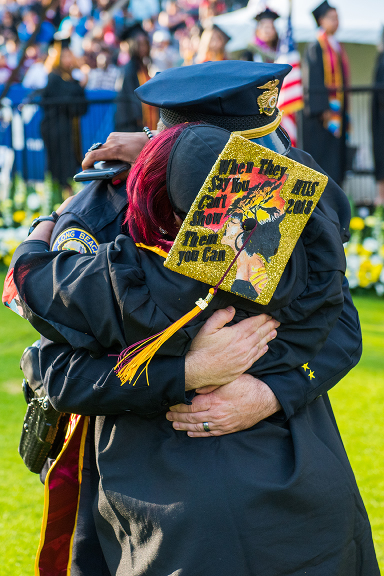 Graduate Tiffany Hall hugs Lt. Jim Foster, Long Beach Police Department.