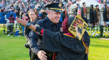 Tiffany Hall hugs Lt. Jim Foster at her graduation ceremony