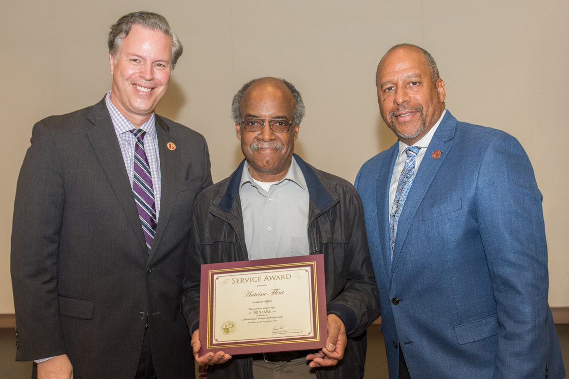 Antoine (Tony) Flint, honored for 50 years of service during CSUDH 2018 Staff Awards ceremony, joins left) Provost and Vice President for Academic Affairs Michael Spagna. and President Thomas A. Parham.