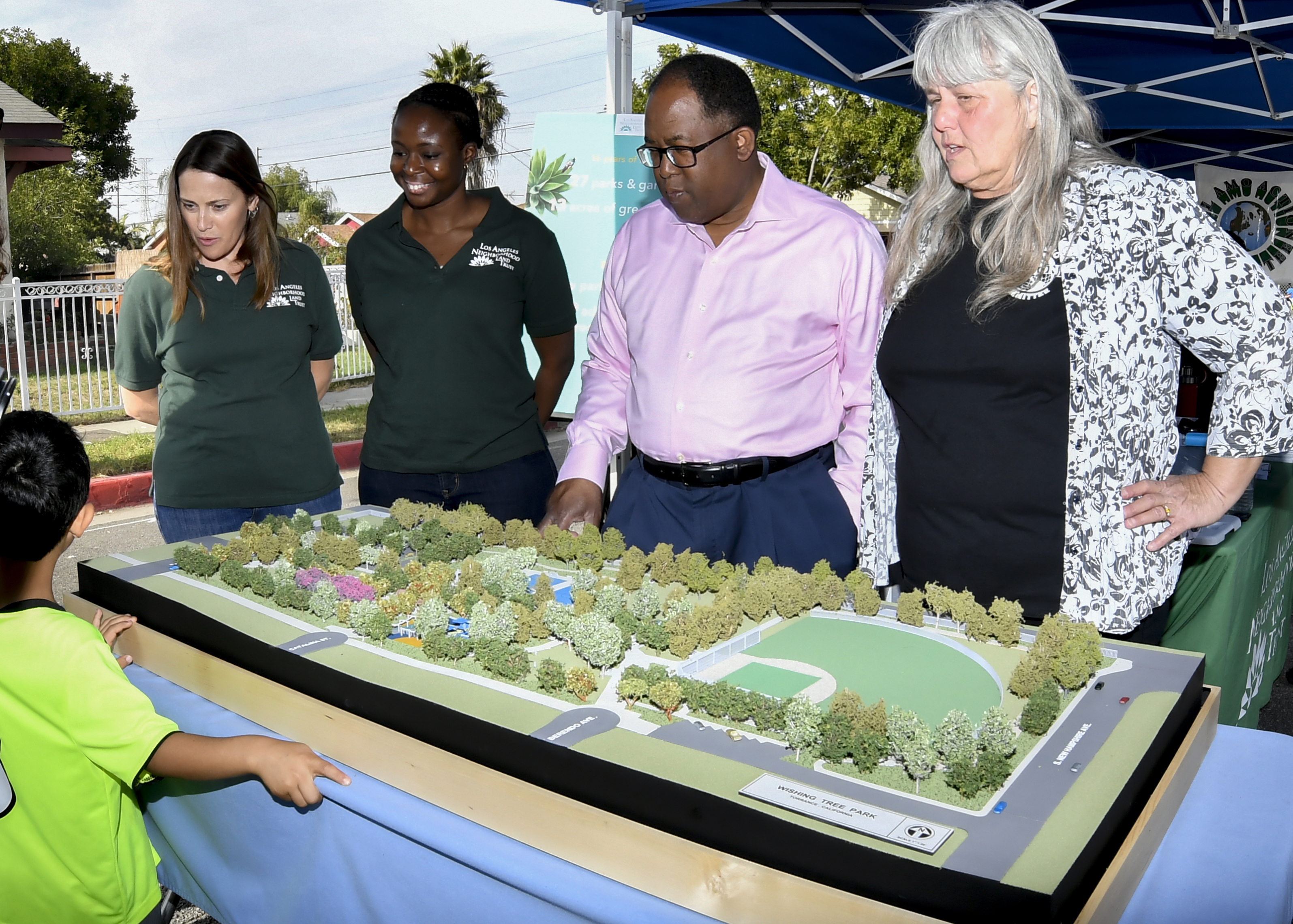 Supervisor Mark Ridley-Thomas and members of the check out a model of Wishing Tree Park.