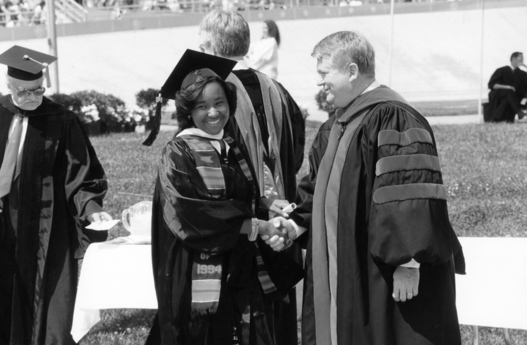 President Robert Detweiler congratulates graduate during 1994 commencement at the Velodrome