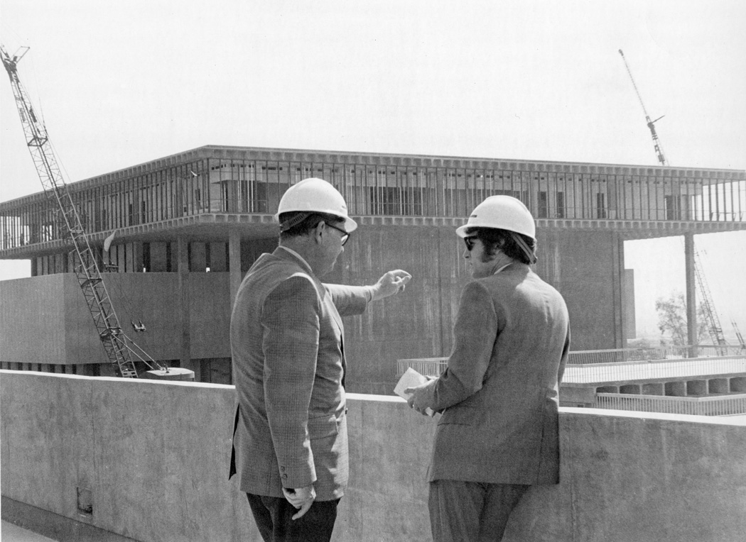 Leo Cain views construction of the library, ca. 1969