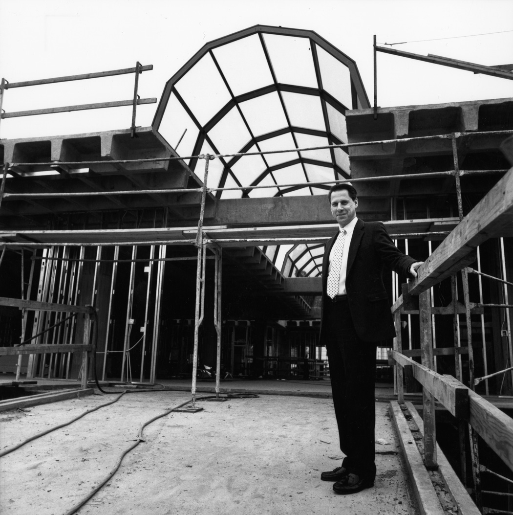 Student Union Director Louis Anderson stands by partially-completed archway at Loker Student Union construction site