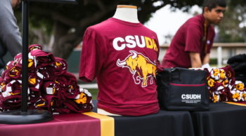 table with CSUDH Tshirt display