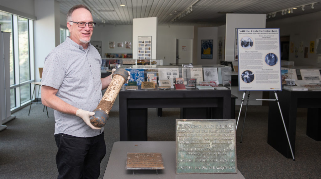 Gregory Williams, director of the Gerth Archives, holds a time capsule buried on the CSUDH campus in 1974 and unearthed in June 2020.