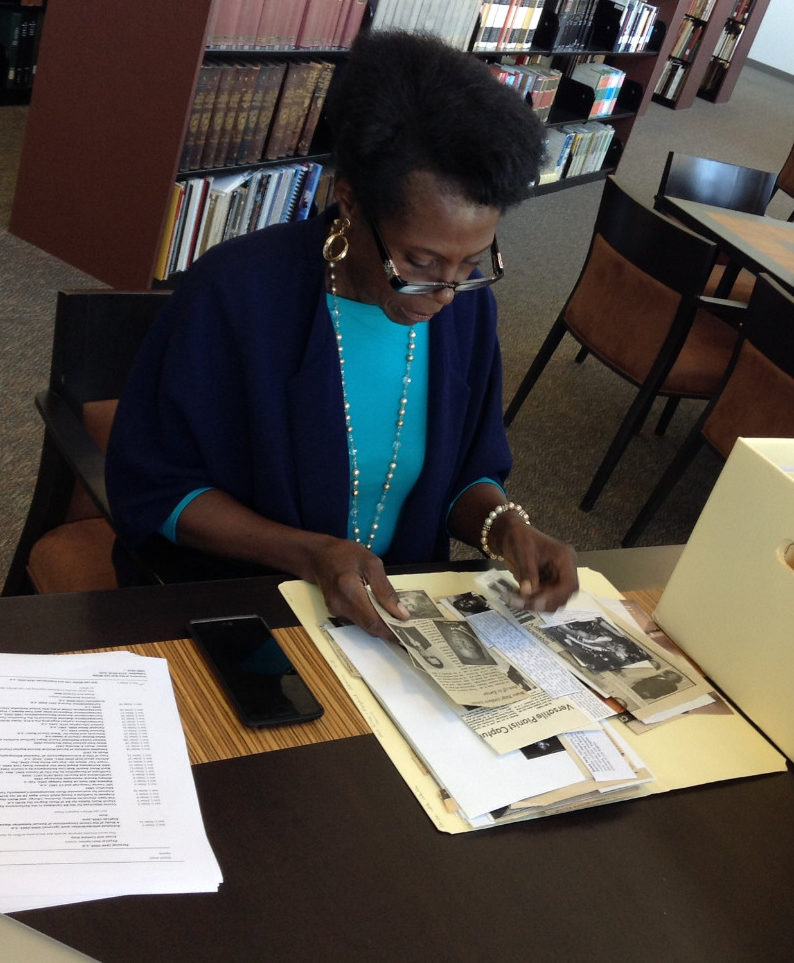 Henrietta Fortson, a national officer of the National Association of Negro Musicians, examines the Don Lee White Collection in CSUDH's Gerth Archives and Special Collections. Photo by Judith Blakely.