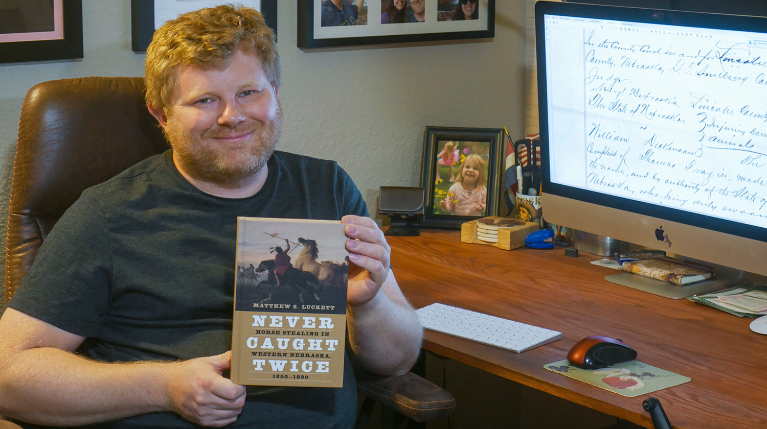 Mathew Luckett with his new book “Never Caught Twice: Horse Stealing in Western Nebraska, 1850–1890.”