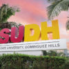 CSUDH campus sign framed by palm trees