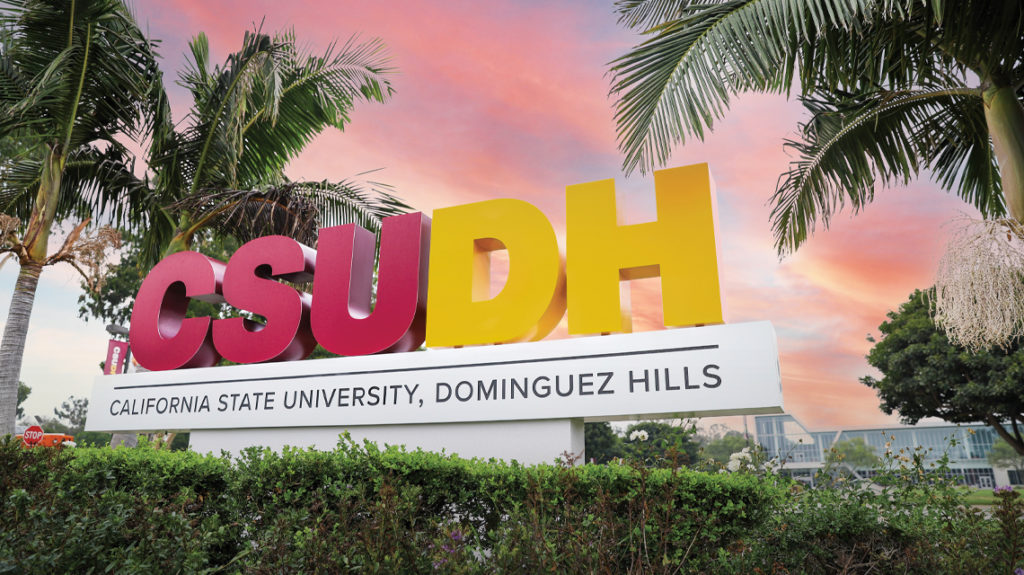 CSUDH campus sign framed by palm trees