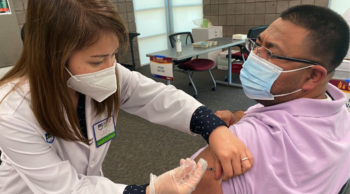 A student receives a vaccine