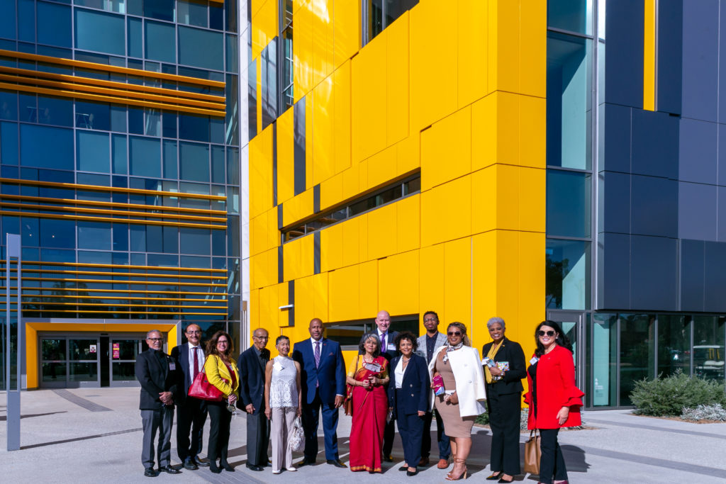 Administrators and guests pose outside the Innovation and Instruction Building.