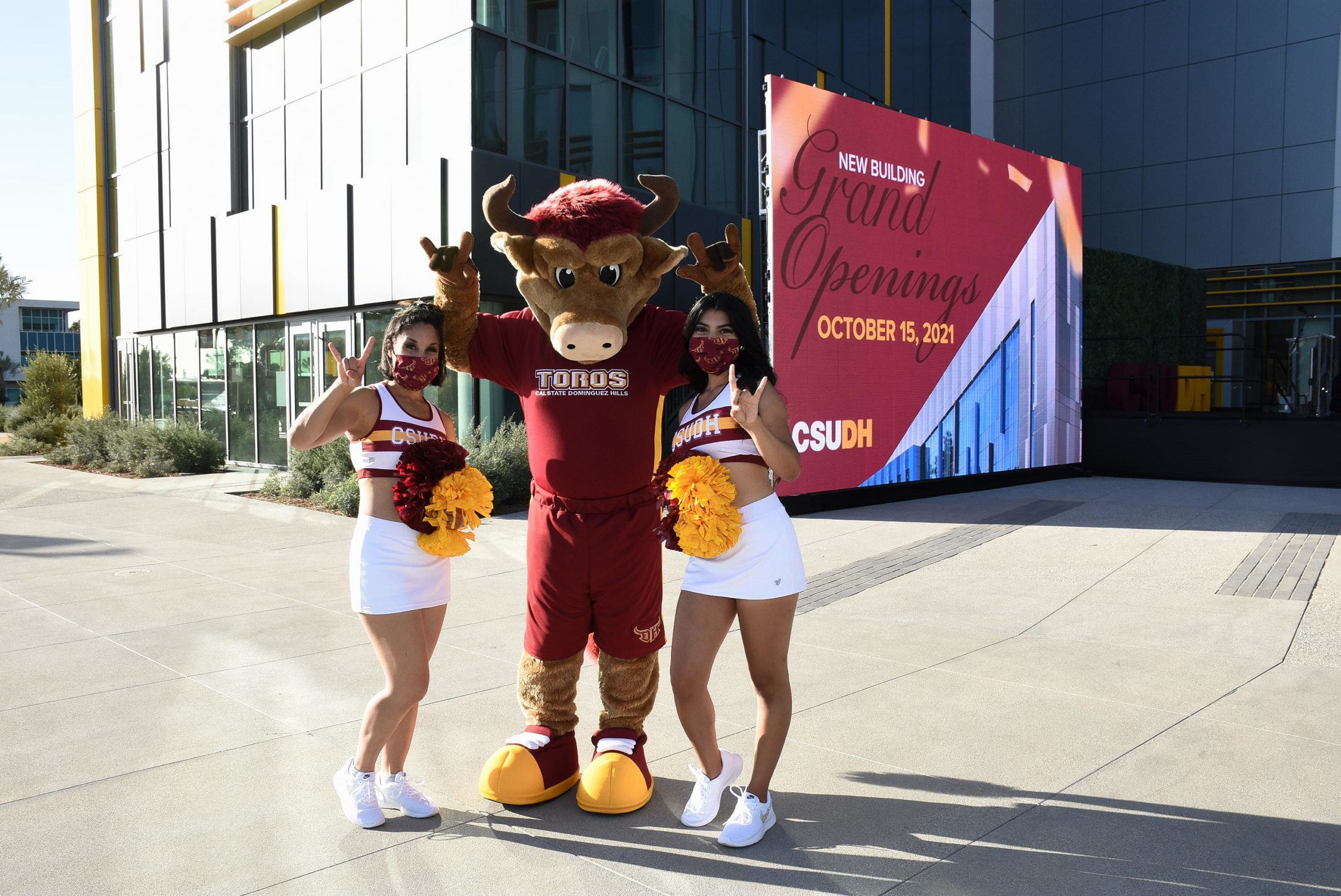 CSUDH mascot Teddy the Toro poses with members of the CSUDH Dance Team outside the Innovation and Instruction Building.