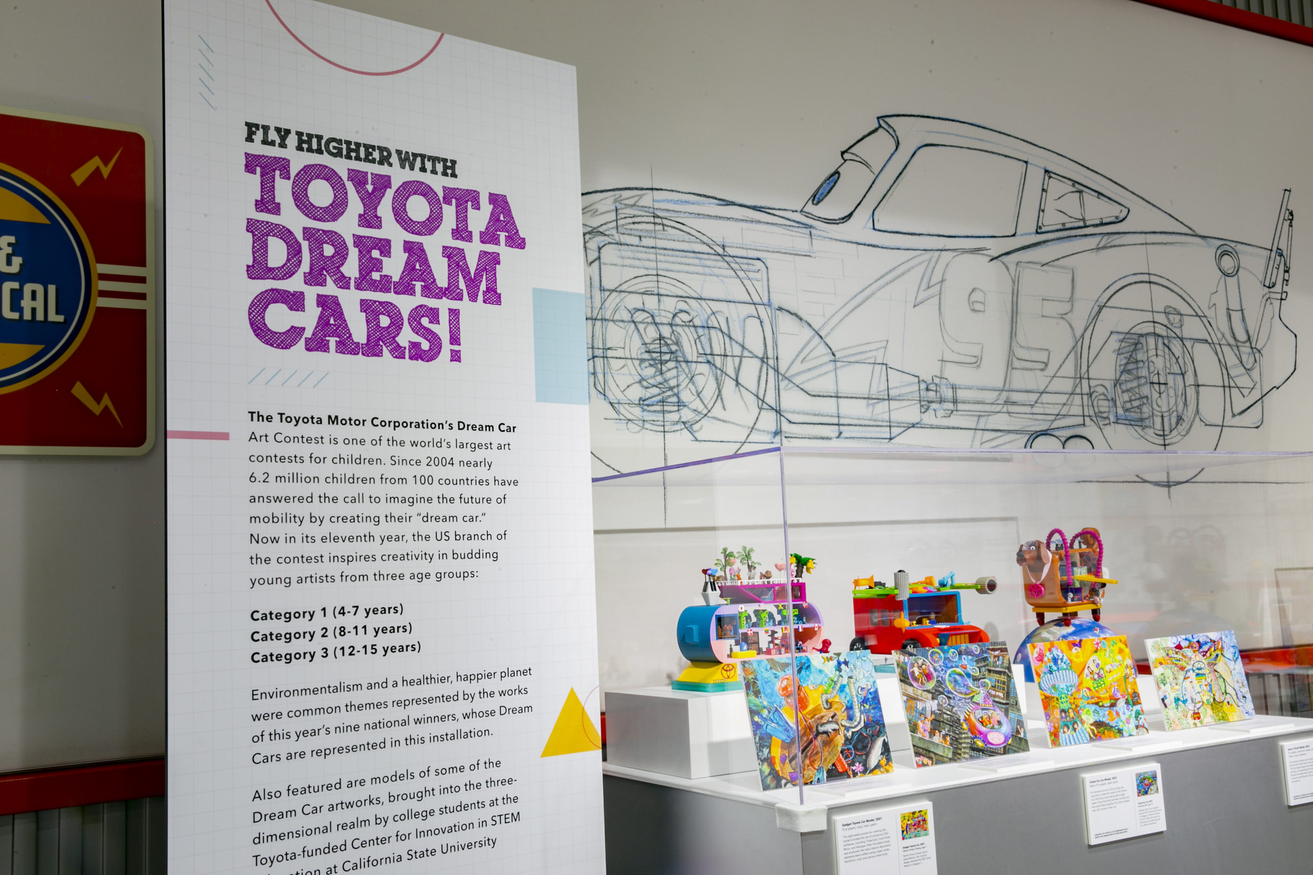 A display of the Toyota Dream Car models inside the Petersen Automotive Museum, with a large display sign describing the project.
