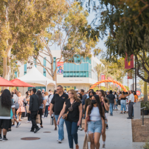 The CSUDH campus west walkway filled with people.