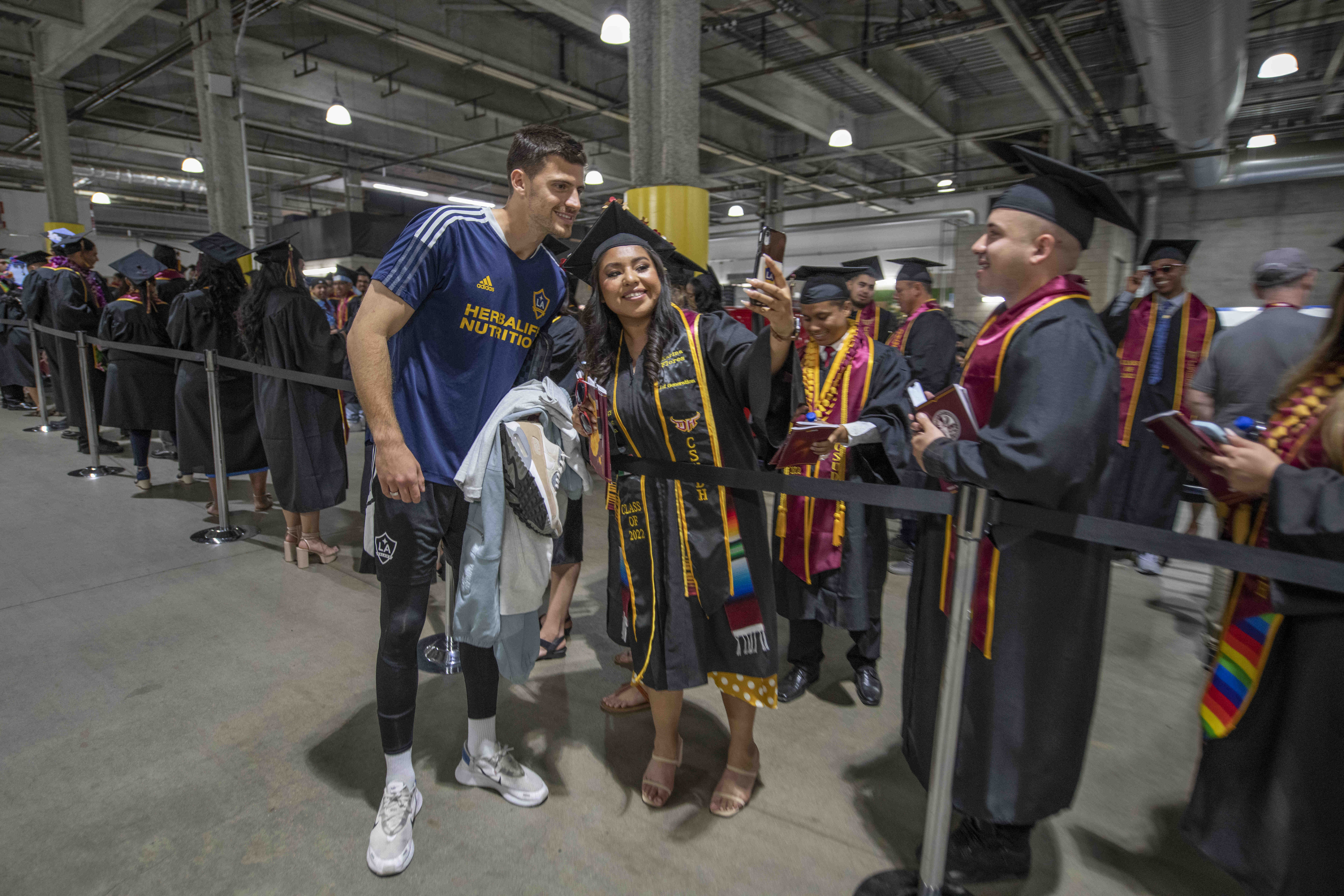 A graduate with a Galaxy soccer player