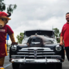 Teddy the Toro and student from Scholars United with low rider car