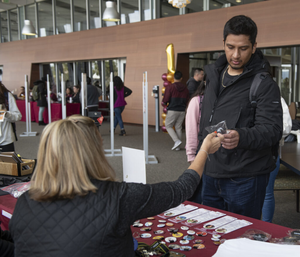 Student picks up CSUDH promo gifts at fourth annual First Generation College Students celebration