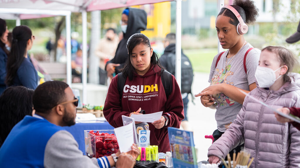 Students speak to an exhibiter at the 16th annual Earth Day Festival on April 18.