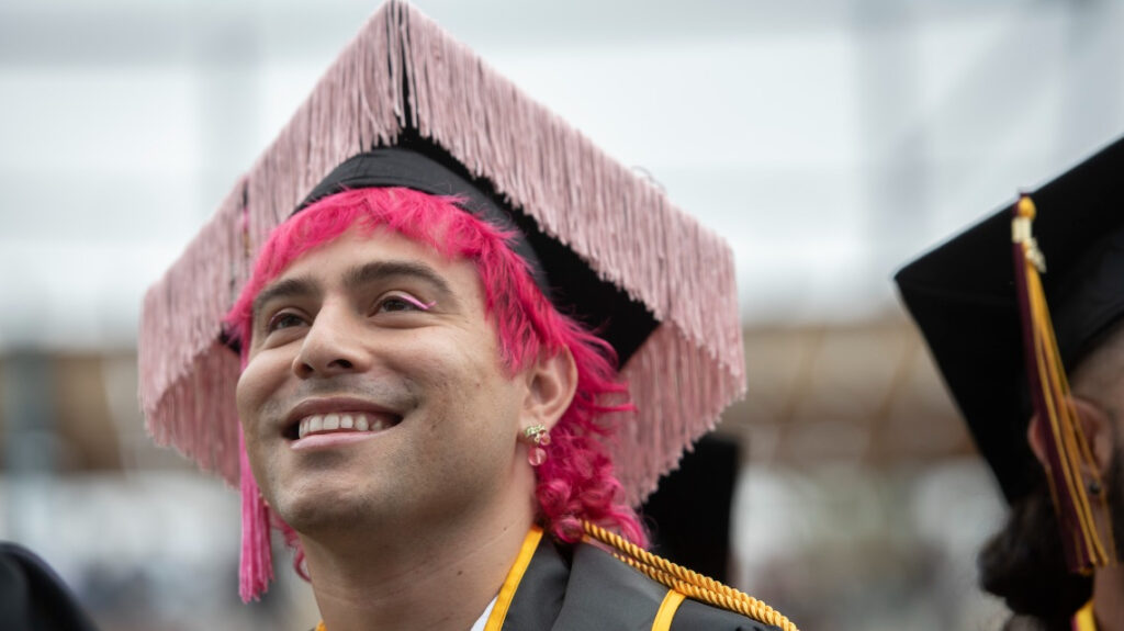 Smiling grad with pink tassled cap