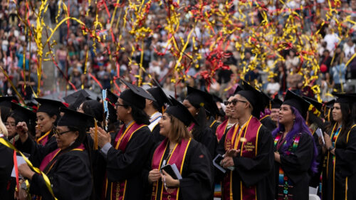 Streamers fall onto graduates celebrating at Commencement.