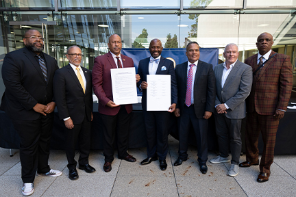 Signatories to the Compton Community Health Professions Partnership pose for a group photo with he signed agreement.