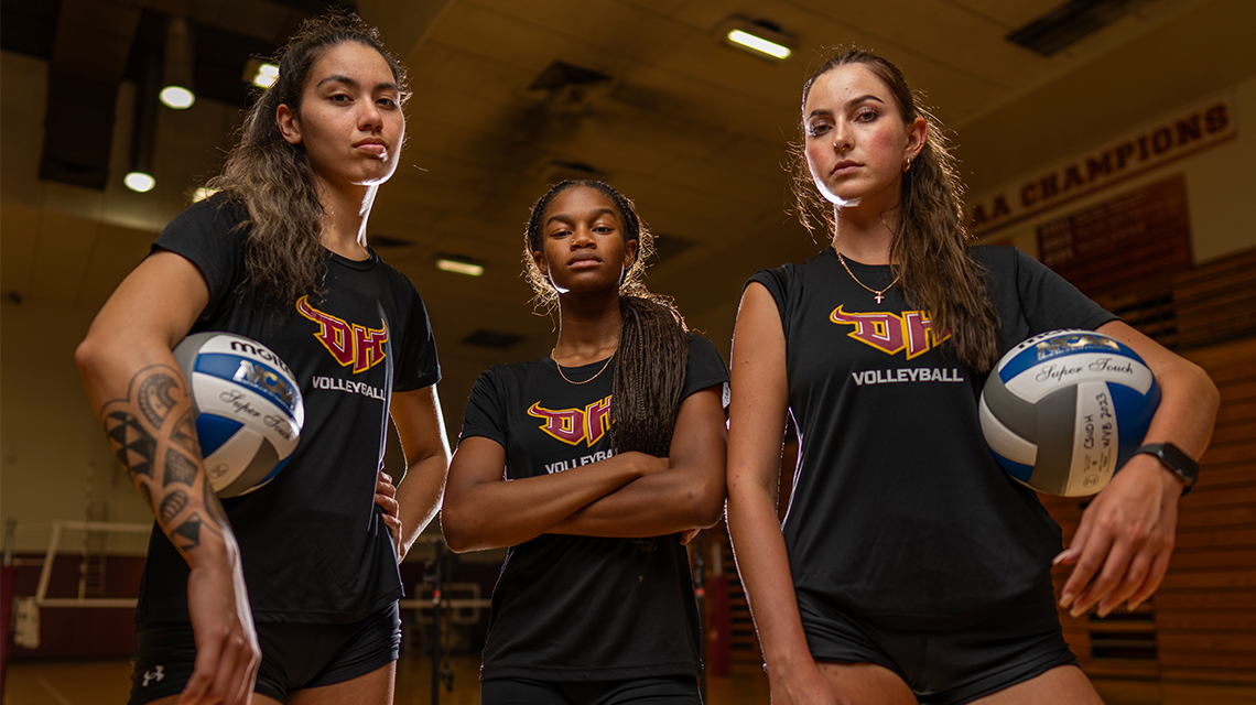 Toro women's volleyball players pose in the CSUDH gym.