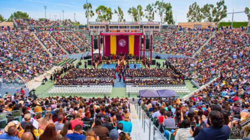 View of graduates, stadium, and stage at CSUDH commencement