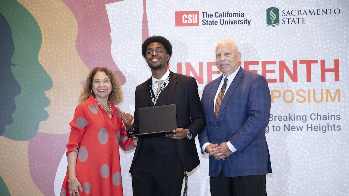 Egere onstage at the Juneteenth symposium accepting his scholarship award.