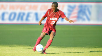 Kei Kamara playing soccer for CSUDH on a field.