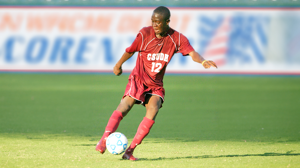 Kei Kamara playing soccer for CSUDH on a field.